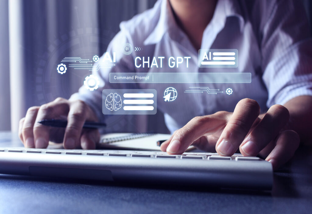 Pessoa usando computador com ícones digitais representando ChatGPT e inteligência artificial