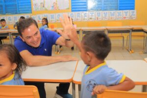 Prefeito Mateus Assayag cumprimenta uma criança em sala de aula durante agenda em escola municipal de Parintins.