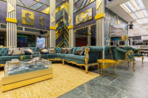 Sala da casa do BBB 26 com decoração em tons de verde e dourado